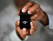 Hands holding a ring inside a ring box