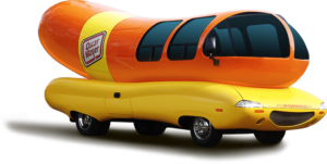 The Oscar Mayer Weinermobile with orange hotdog and yellow bun/carriage.